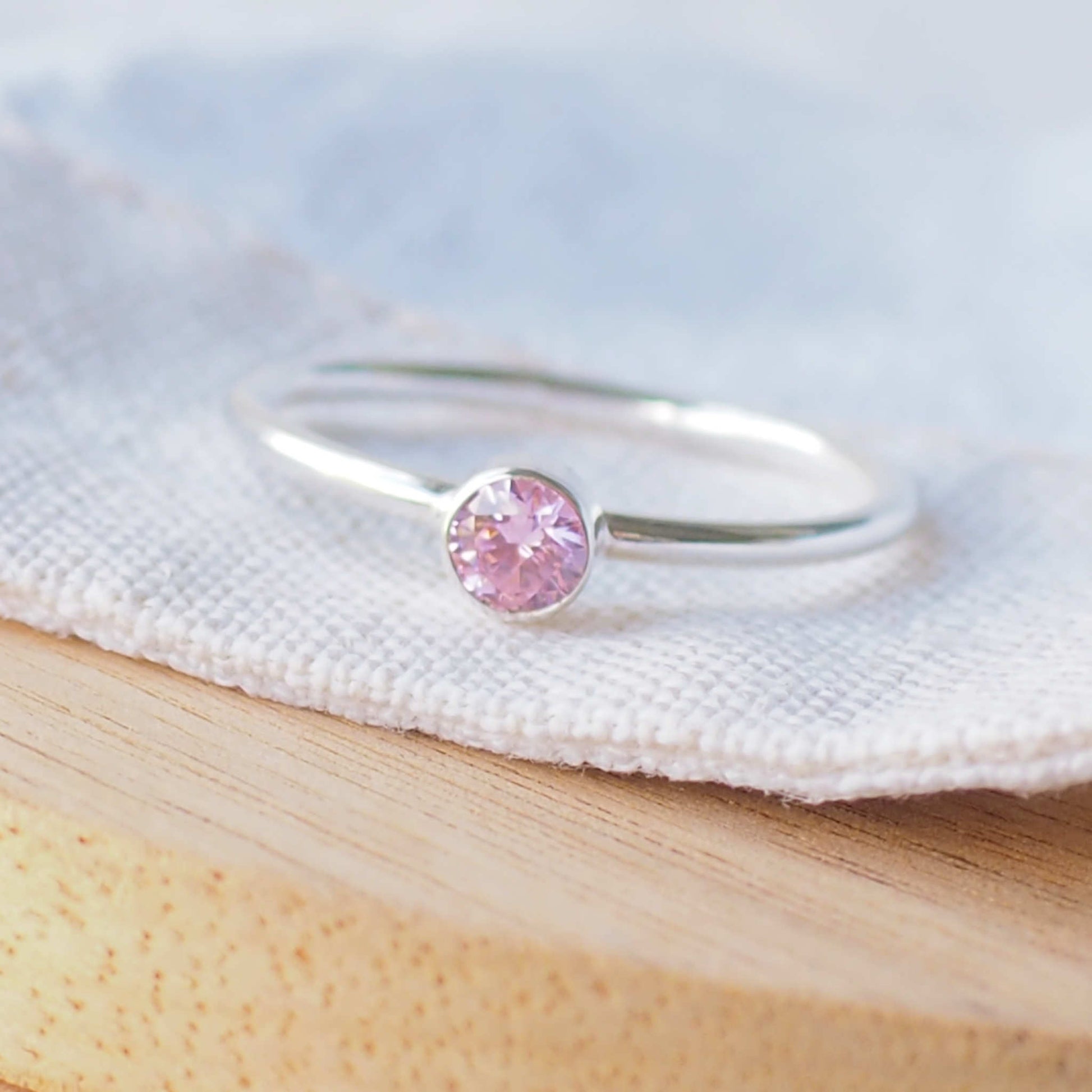 Pale Pink and Silver gemstone ring with a solitaire cubic zirconia on a silver band, The ring is minimalist in style with no decoration with a round 4mm pink gemstone on a fully round band. made in Scotland by maram jewellery