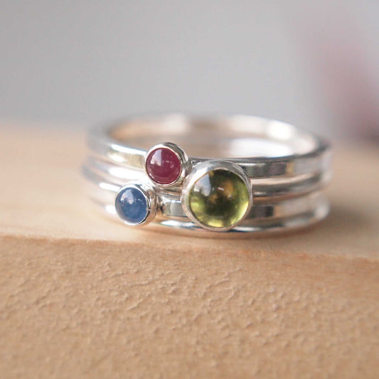 Three Solitaire Ring set with Peridot, ruby and sapphire gemstones. Handmade by maram jewellery in UK