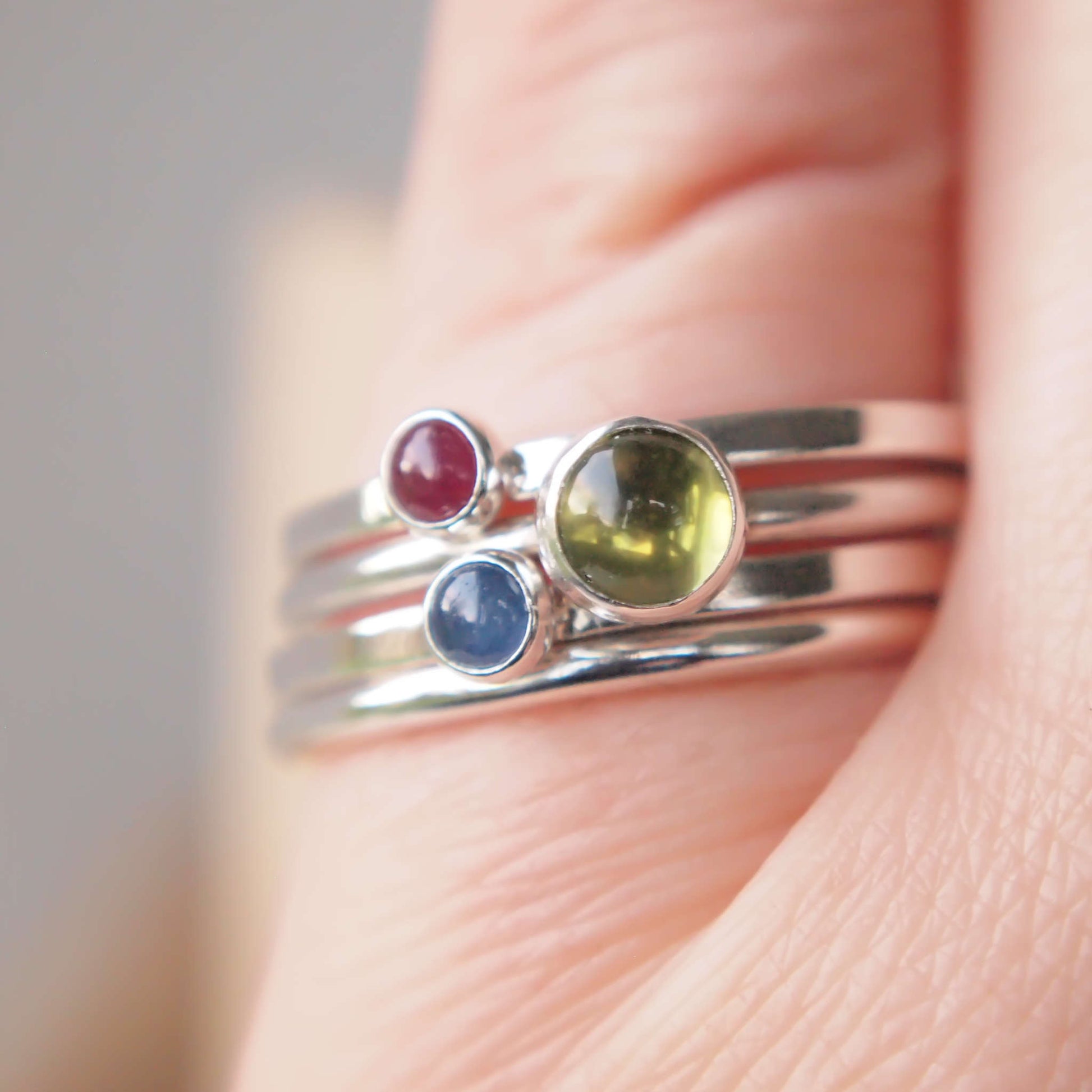 Three Solitaire Ring set with Peridot, ruby and sapphire gemstones. Handmade by maram jewellery in UK