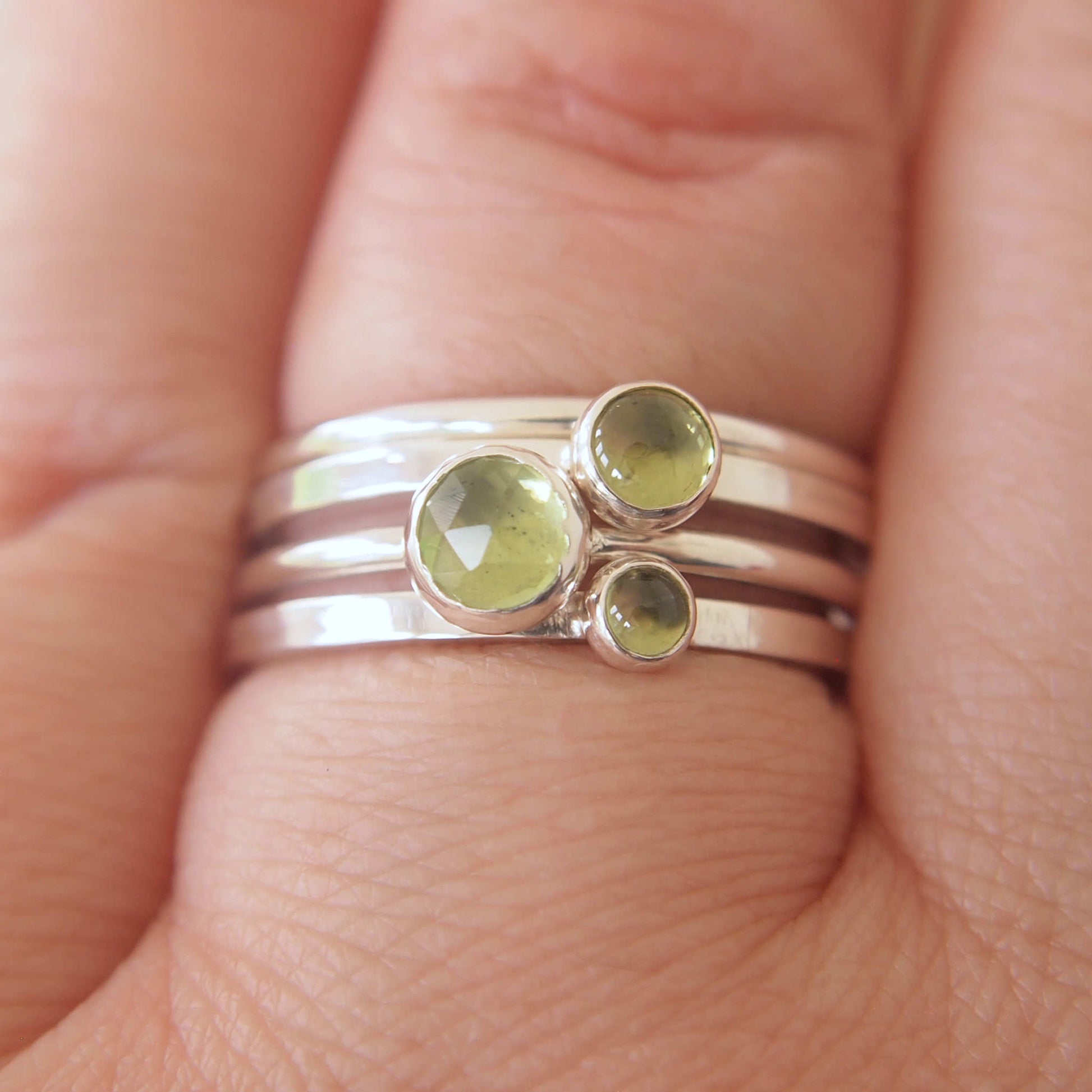 Three ring set in Sterling silver and different sizes of round Peridot, ranging in size from 3mm to 5mm. The rings are simple and minimalist in style. Handmade Jewellery from UK