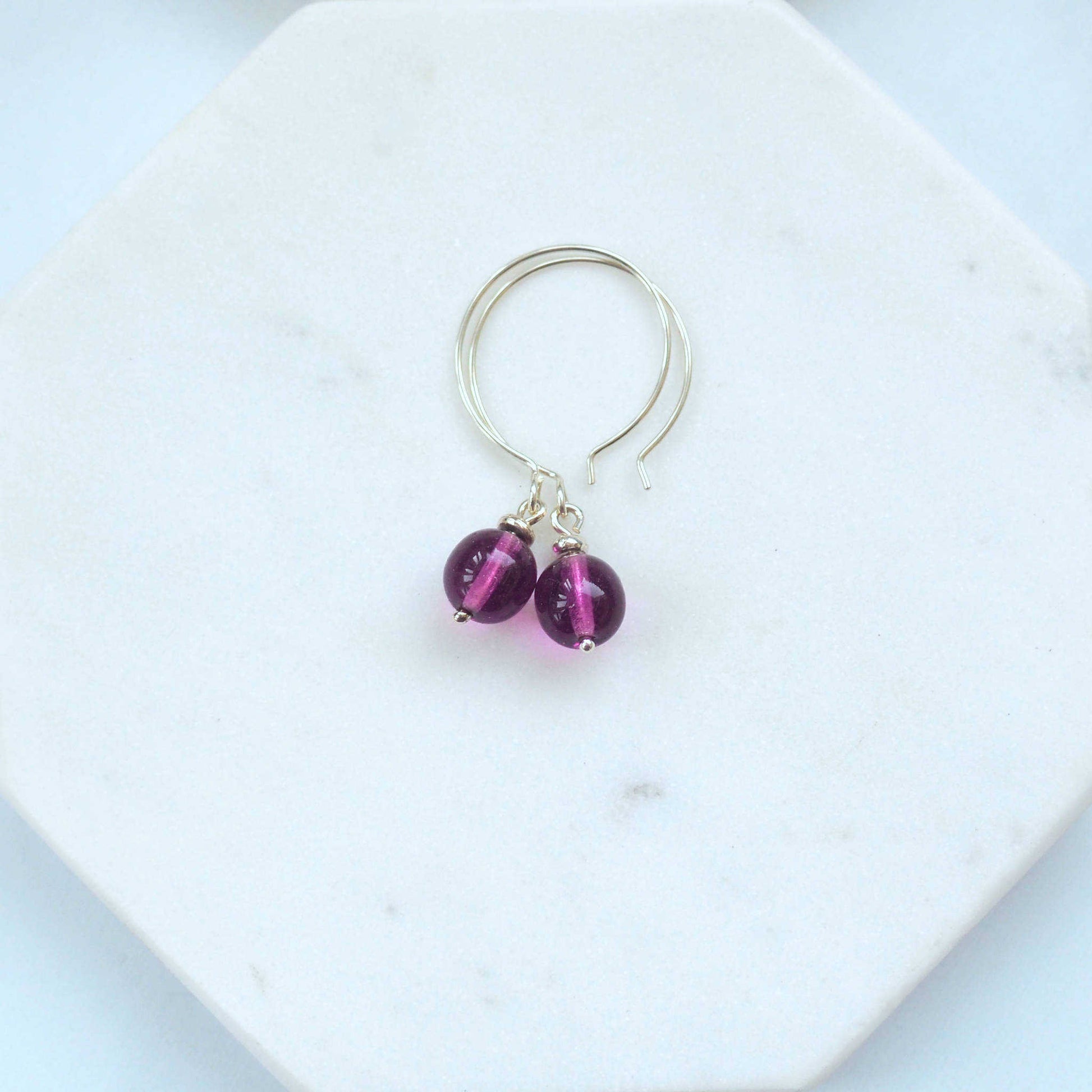 Purple Silver minimalist handmade silver hoops. Handcrafted ear wires with a round glass bead dropper. Made in Scotland by maram jewellery