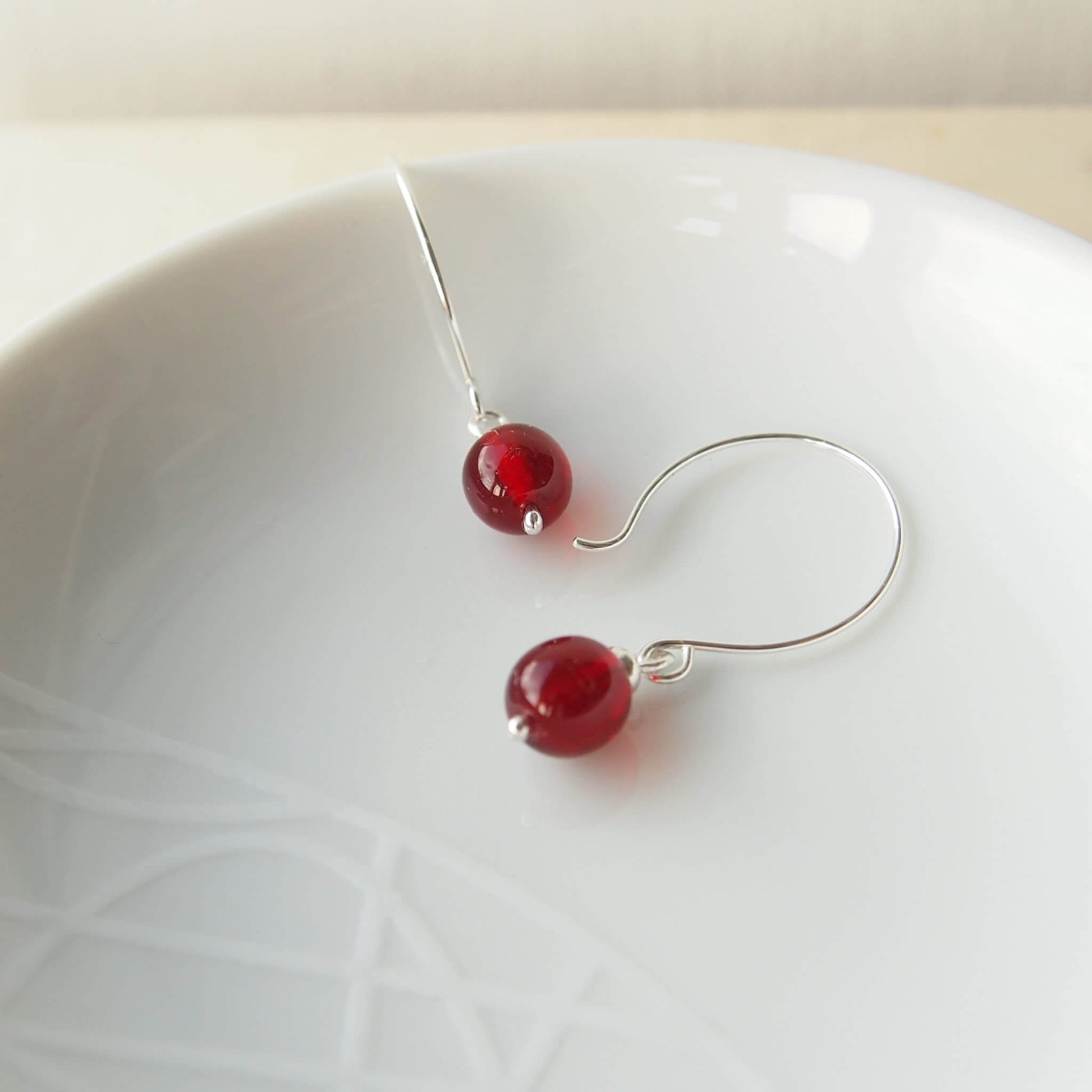 Red Silver minimalist handmade silver hoops. Handcrafted ear wires with a round glass bead dropper. Made in Scotland by maram jewellery