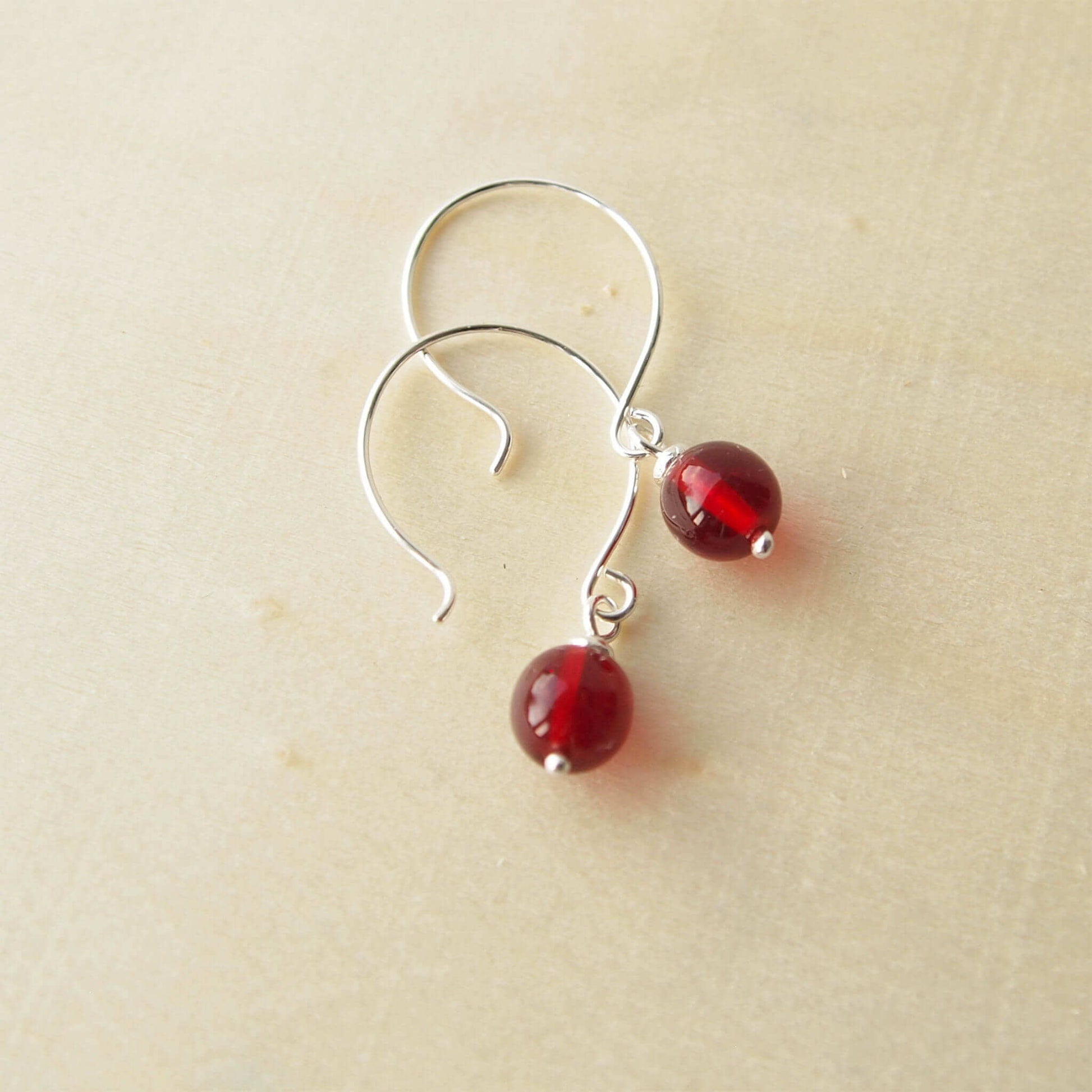 Red Silver minimalist handmade silver hoops. Handcrafted ear wires with a round glass bead dropper. Made in Scotland by maram jewellery