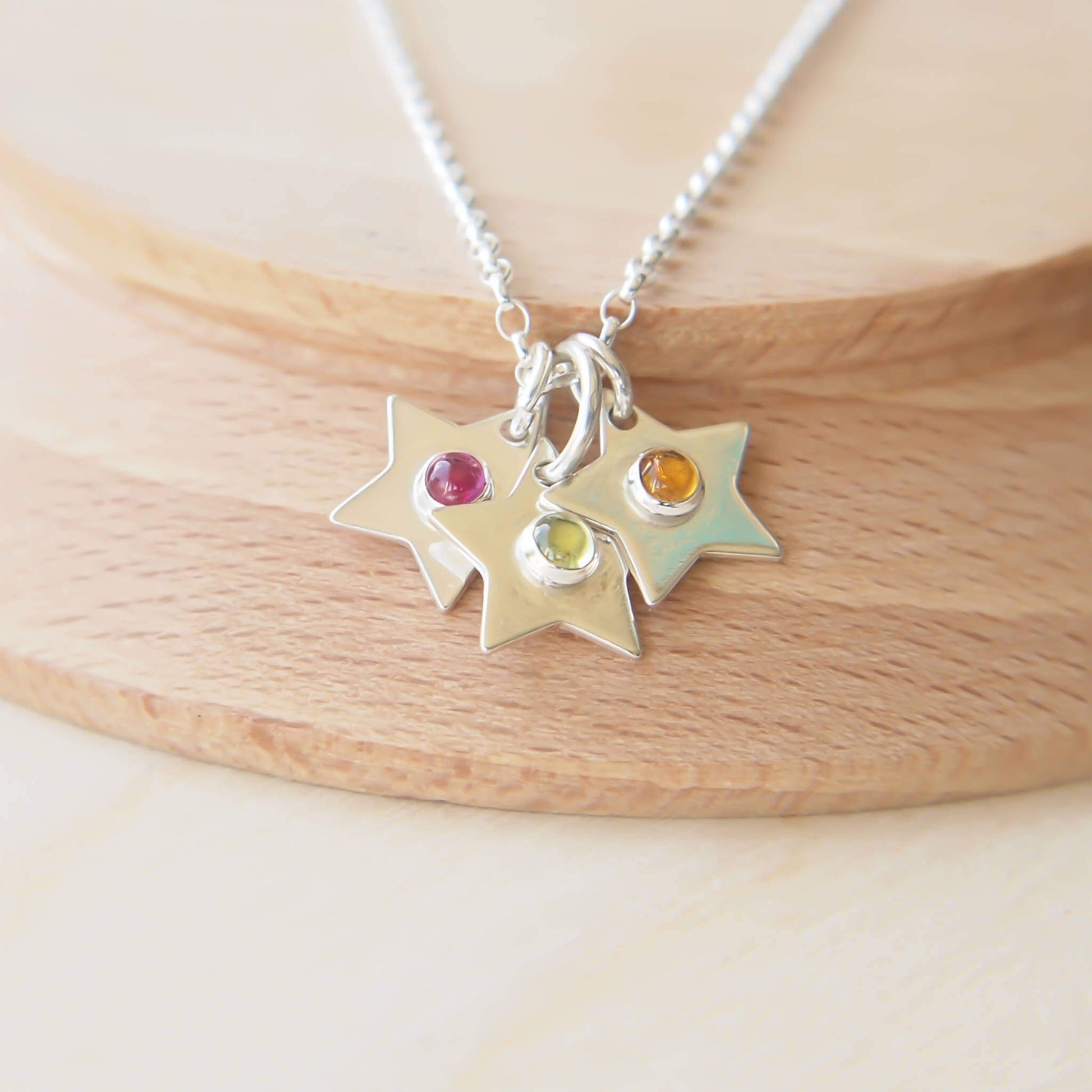 Silver Star Family stars with birthstone centres on Garnet, moonstone and Citrine