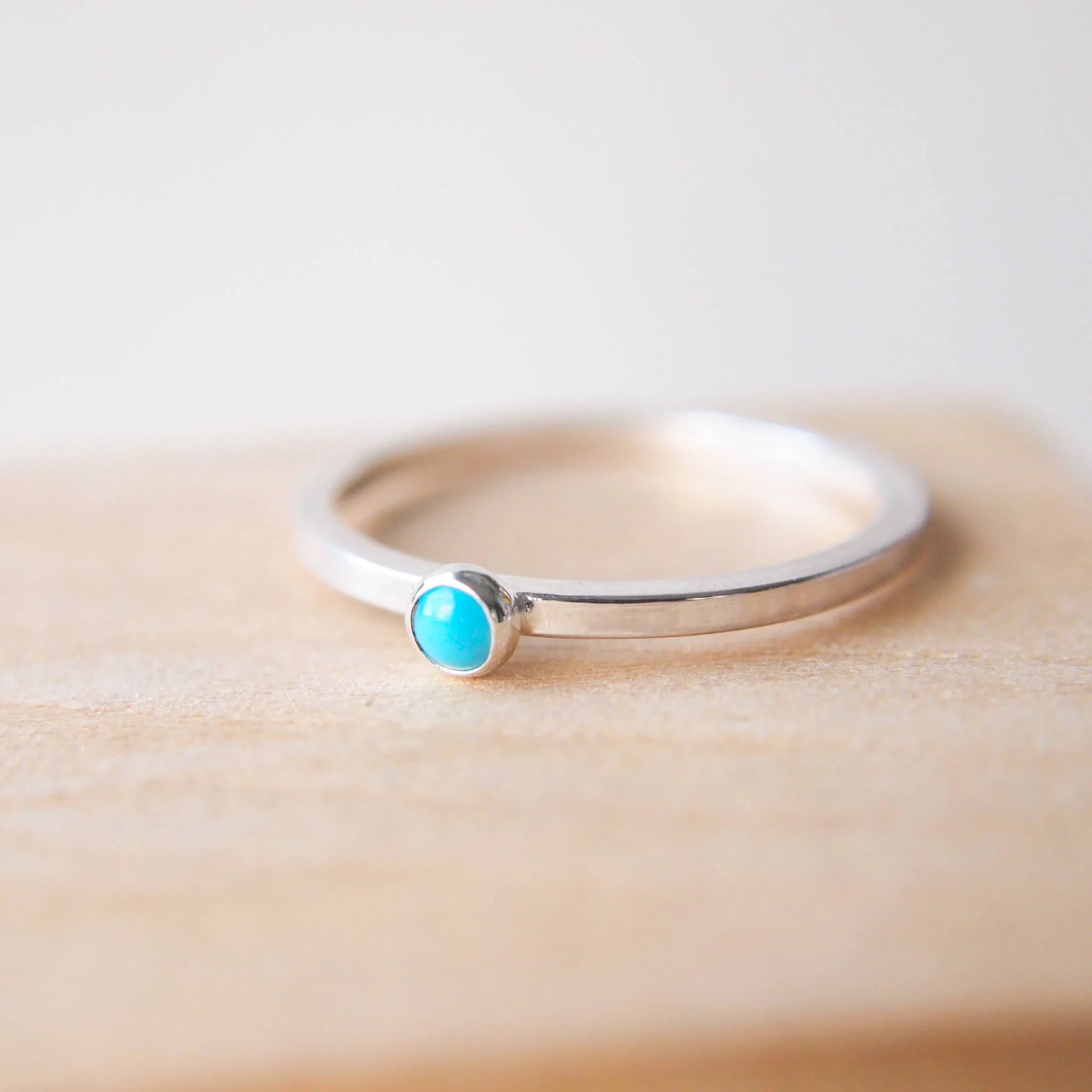Sterling Silver and turquoise cabochon ring with a small 3mm turquoise set onto a simple silver square band ring. Handmade in Scotland by maram jewellery