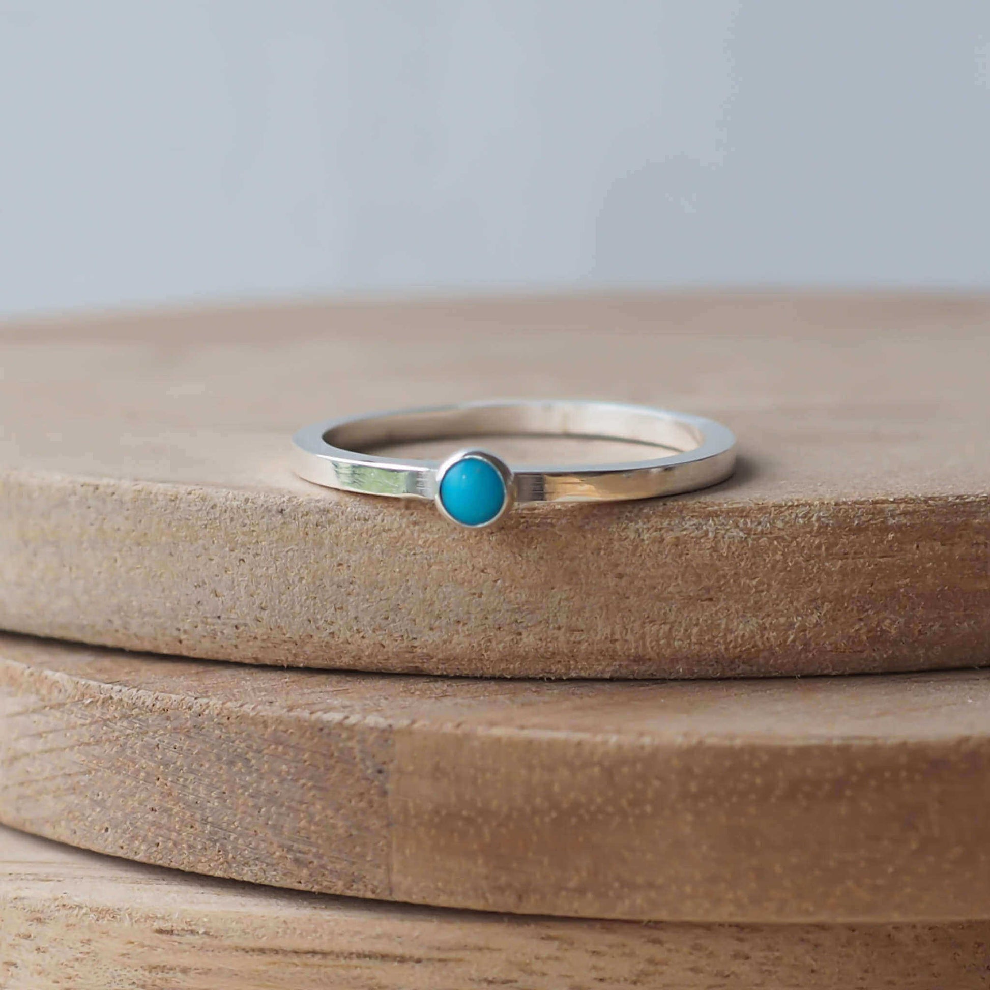 Turquoise and Sterling Silver Ring made from a small 3mm round turquoise gemstone set simply onto a modern band of square wire. Handmade to your ring size by maram jewellery in Scotland